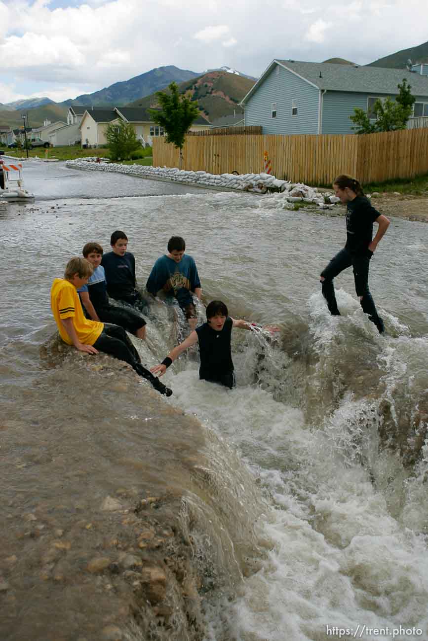 Kids playing in flood water. Flooding along 700 South in Tooele Tuesday.