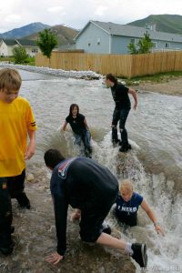 Kids playing in flood water. Flooding along 700 South in Tooele Tuesday.