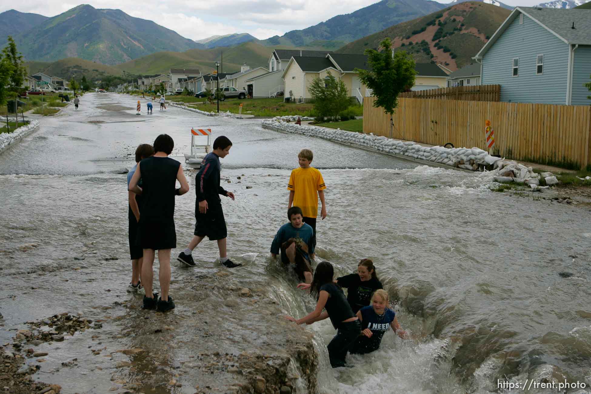 Kids playing in flood water. Flooding along 700 South in Tooele Tuesday.