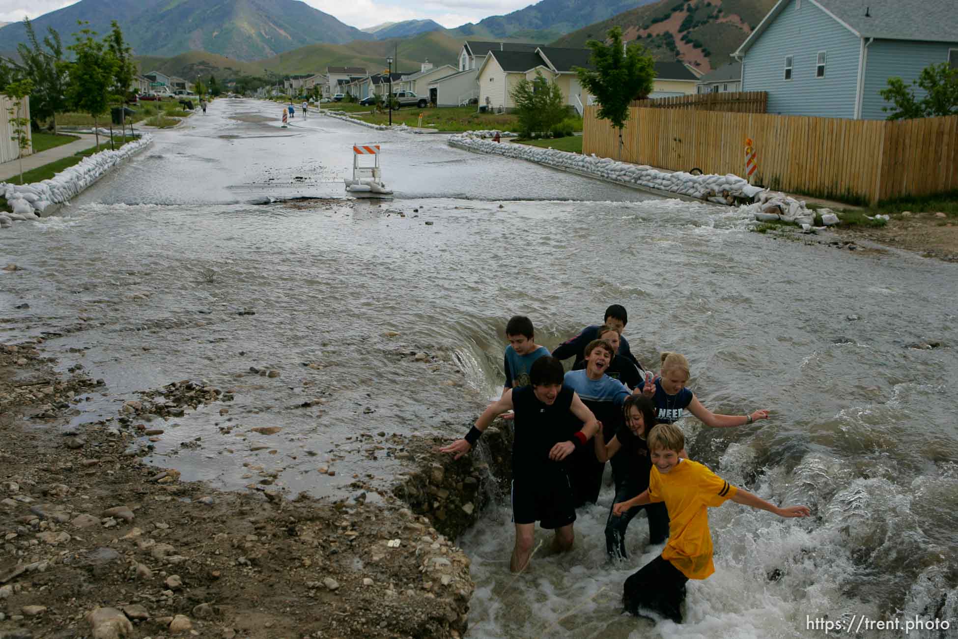 Kids playing in flood water. Flooding along 700 South in Tooele Tuesday.