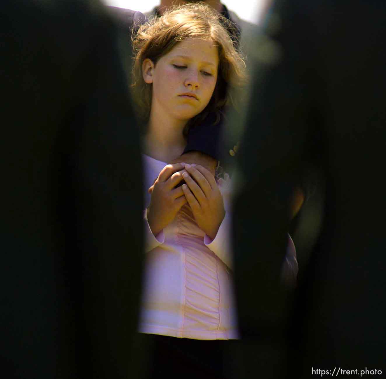 Anna Joy Young, step-sister of Brandon Thomas, is framed by pallbearers at the funeral for Brandon Thomas, a green beret killed in Iraq while working as a civilian security contractor. Thomas was buried at the Utah State Veterans Cemetery in Bluffdale.
Photo by Trent Nelson; 5.24.2005