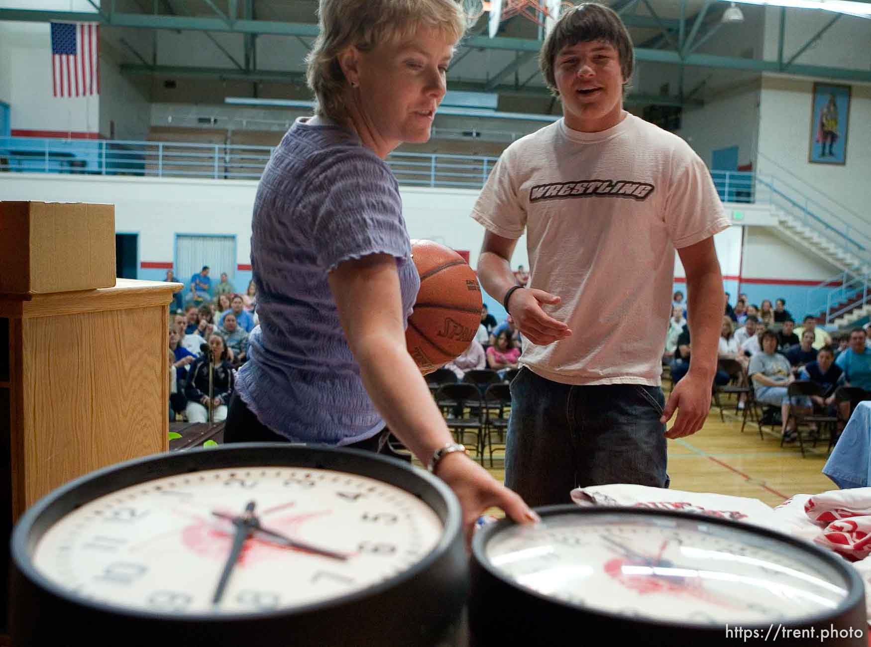 School counselor Karee Hunt, left, helps run a raffle as the school year ends. Students (like Curtis Huitt, right) won prizes including clocks from the school's classrooms and basketballs with the school's logo. The small town of Sunnyside's East Carbon High School is being closed. The students will be transfered to Price's Carbon High School, a 25-minute bus ride away.