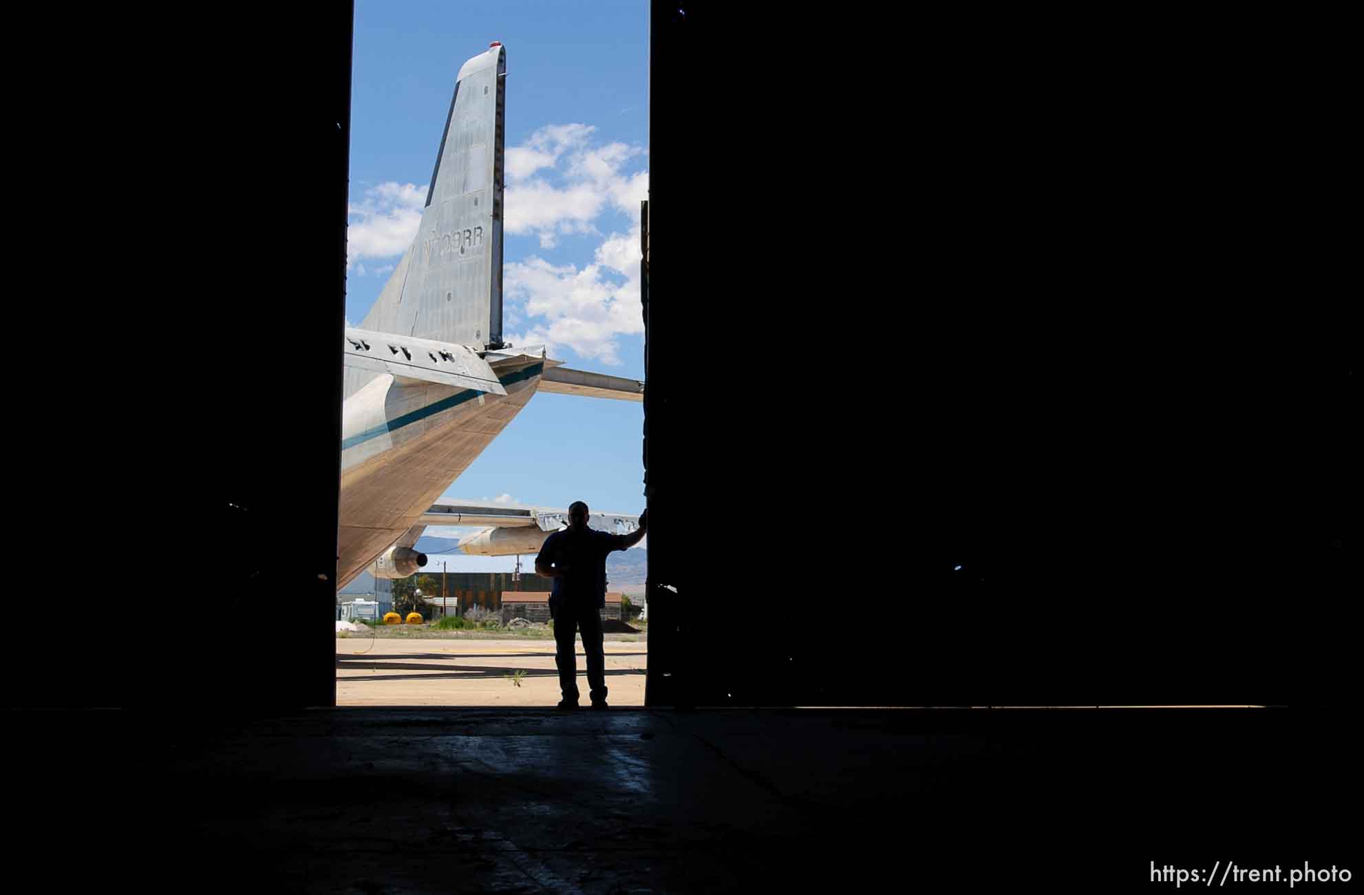 Wendover Airport employee Kevin Linam stands in the doorway of the historic hangar that housed the Enola Gay, the bomber that dropped the atomic bomb on Hiroshima, Japan in 1945. The hangar is currently used for storage. The plane in the background is the C-123 used in the film Con Air.