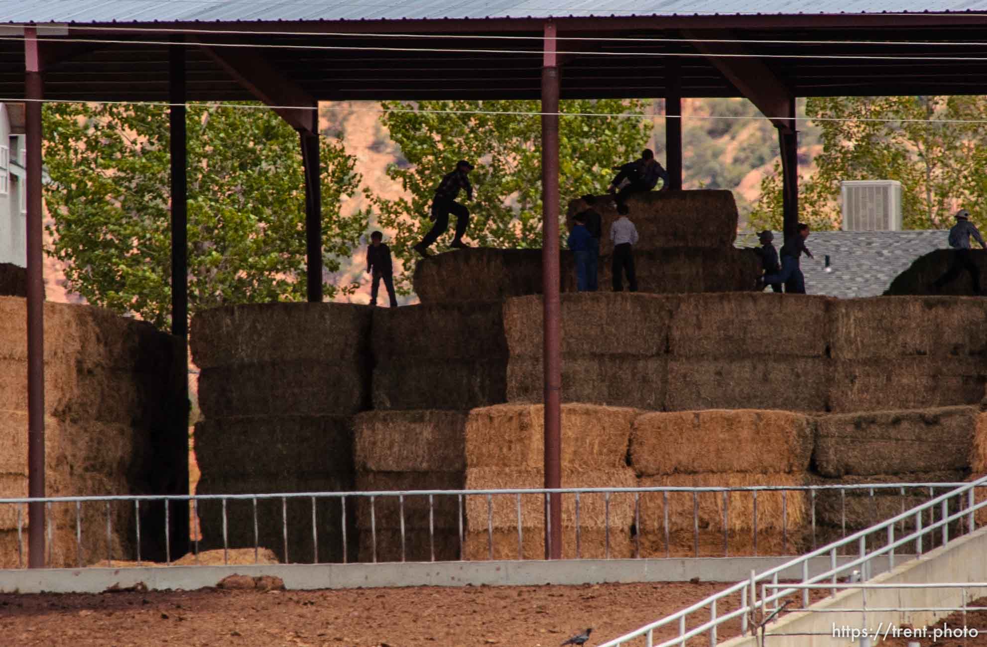 Boys leaping on hay bales, Colorado City