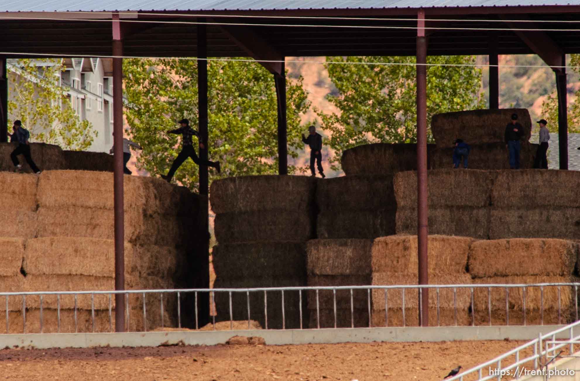 Boys leaping on hay bales, Colorado City