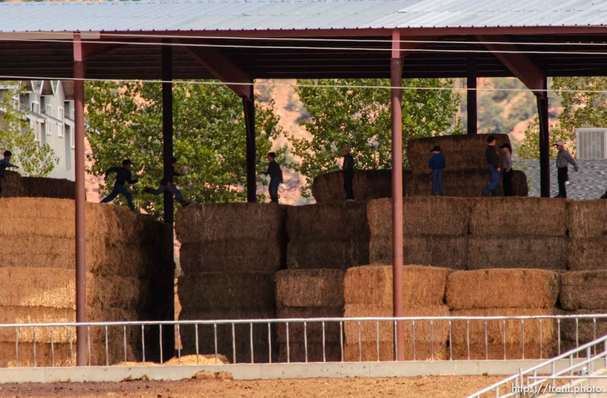 Boys leaping on hay bales, Colorado City