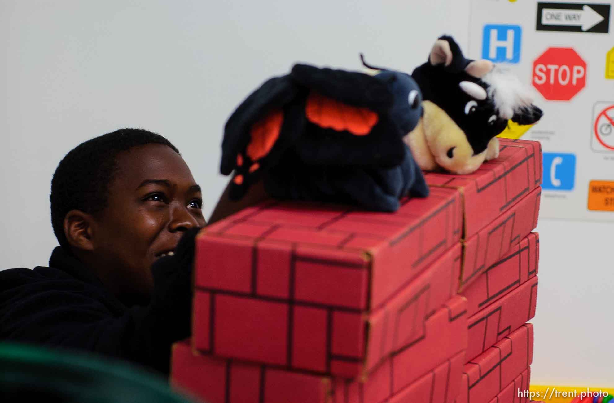 boy doing puppet show in day care center at Camp Williams, where people who were evacuated from the hurricane Katrina disaster in New Orleans, are making a go of it.