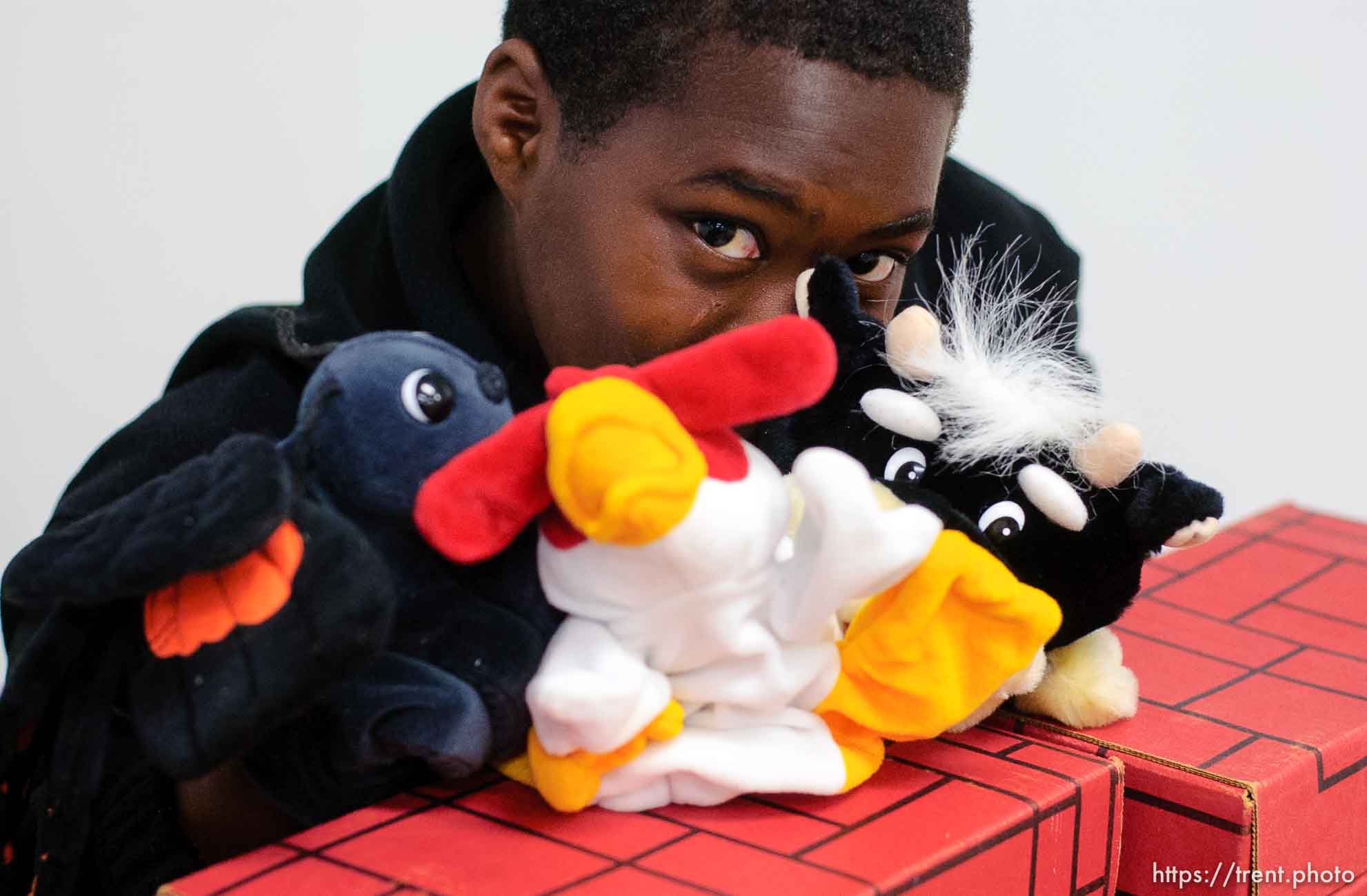 boy doing puppet show in day care center at Camp Williams, where people who were evacuated from the hurricane Katrina disaster in New Orleans, are making a go of it.