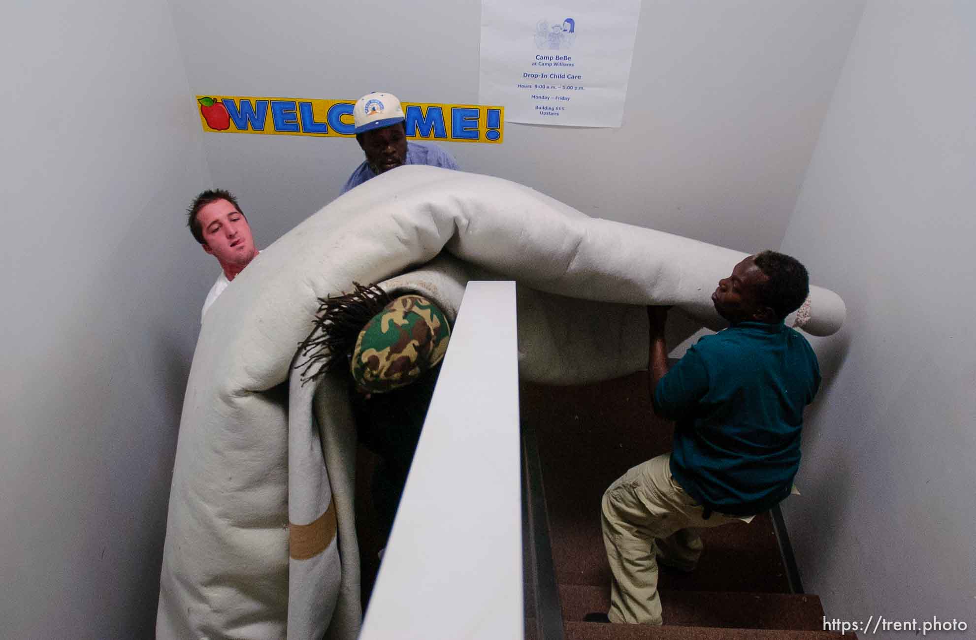 people bringing in donated carpet at Camp Williams, where people who were evacuated from the hurricane Katrina disaster in New Orleans, are making a go of it.