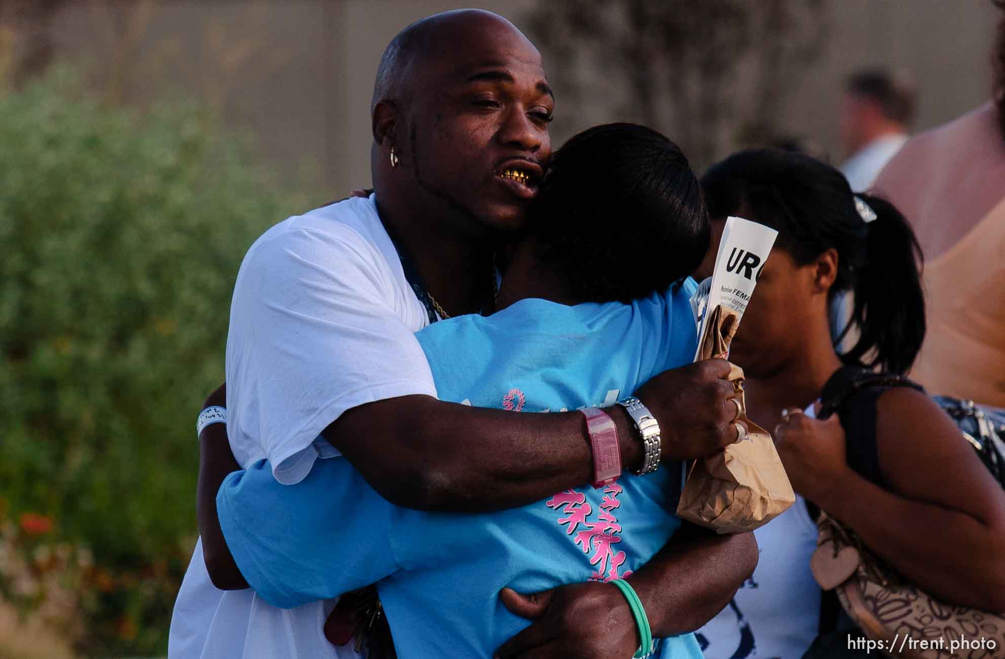 With tears streaming down his face, Jacob Burton of New Orleans hugs his cousin, Troylynn Wilson, before he was to board a bus for Dallas, Texas. Wilson was staying behind at Camp Williams while she decided what to do and where to go. About 100 of the 600 or so evacuees housed at Camp Williams boarded buses to Dallas, Texas Wednesday evening. From Dallas, they will make they way to a variety of locations and reunite with friends and family members.