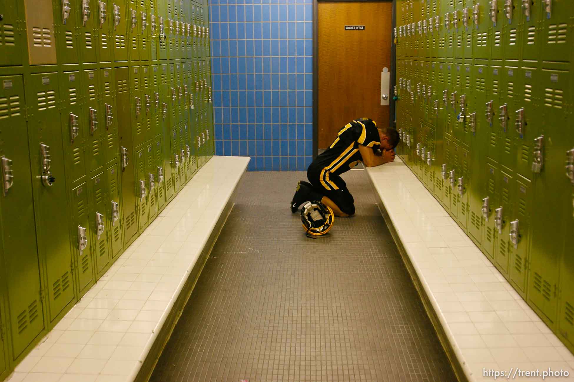 Cottonwood's Cody Williams prays pre-game in the locker room. Cottonwood vs. Highland high school football.