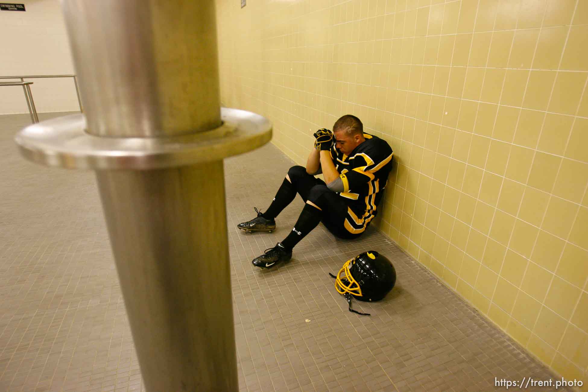 Cottonwood's Casey Riley prays pre-game in the locker room. Cottonwood vs. Highland high school football.