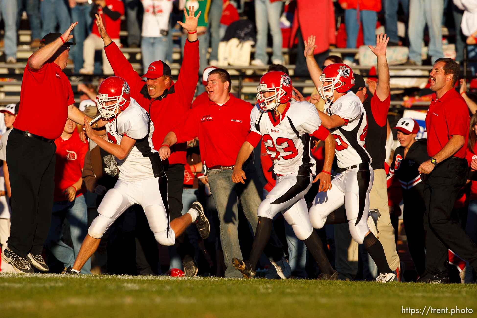 Grand players and coaches swarm onto the field as time runs out and they win 25-22. Grand vs. San Juan, 2A State Football Championship game at Southern Utah University's Eccles Coliseum in Cedar City.