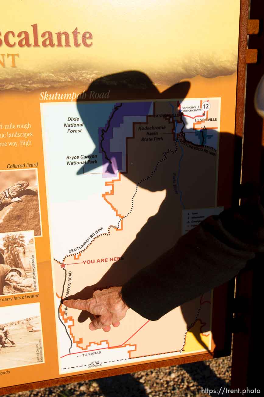 Kane County Commissioner Mark Habbeshaw points to a spot on a BLM map of the Grand Staircase National Monument. The BLM and Kane County have placed conflicting signs on roads in the area. Kane County's signs indicate OHV/ATV access, which the BLM disputes.