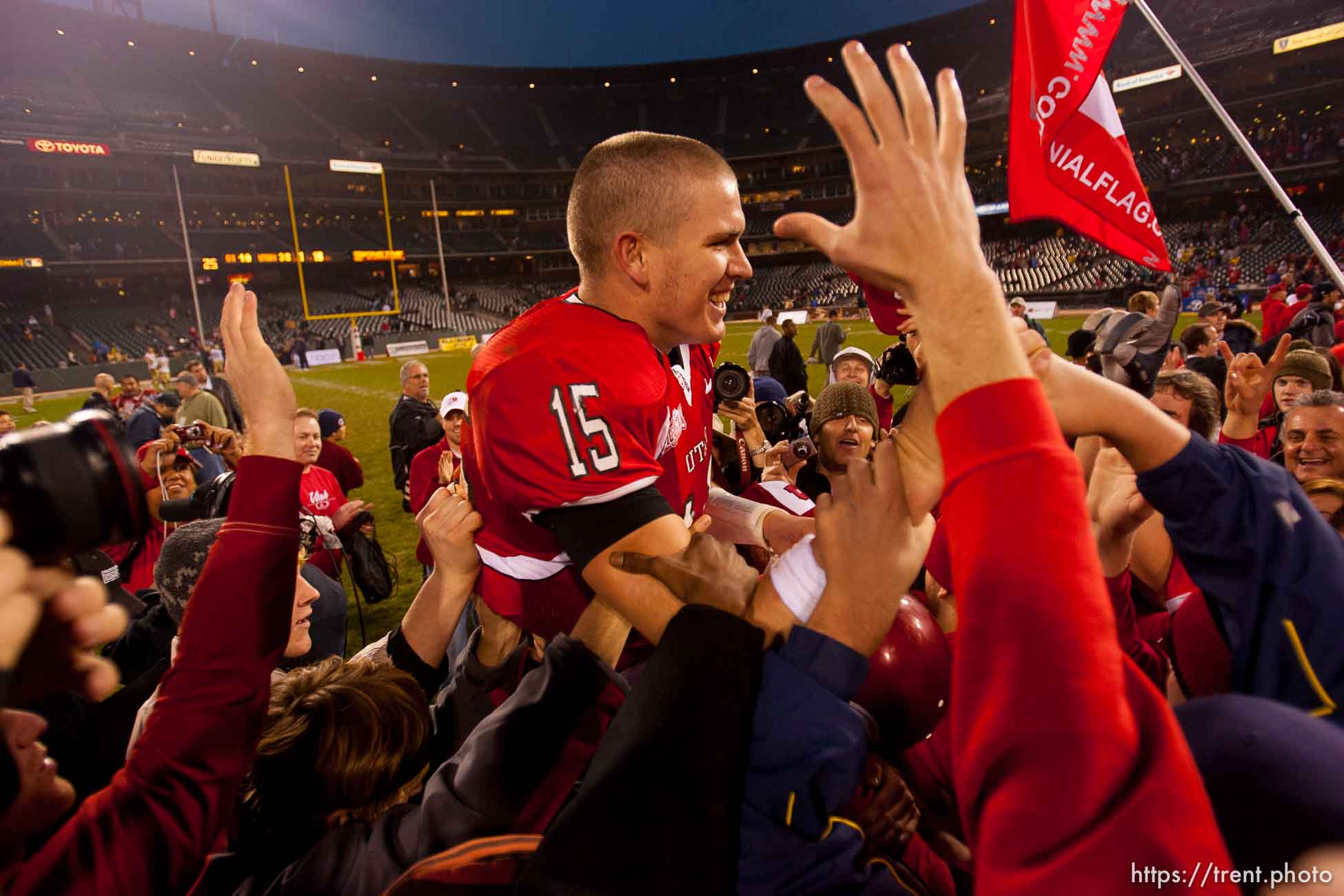 Utah quarterback Brett Ratliff is lifted up by fans after the win. University of Utah vs. Georgia Tech, Emerald Bowl, San Francisco.