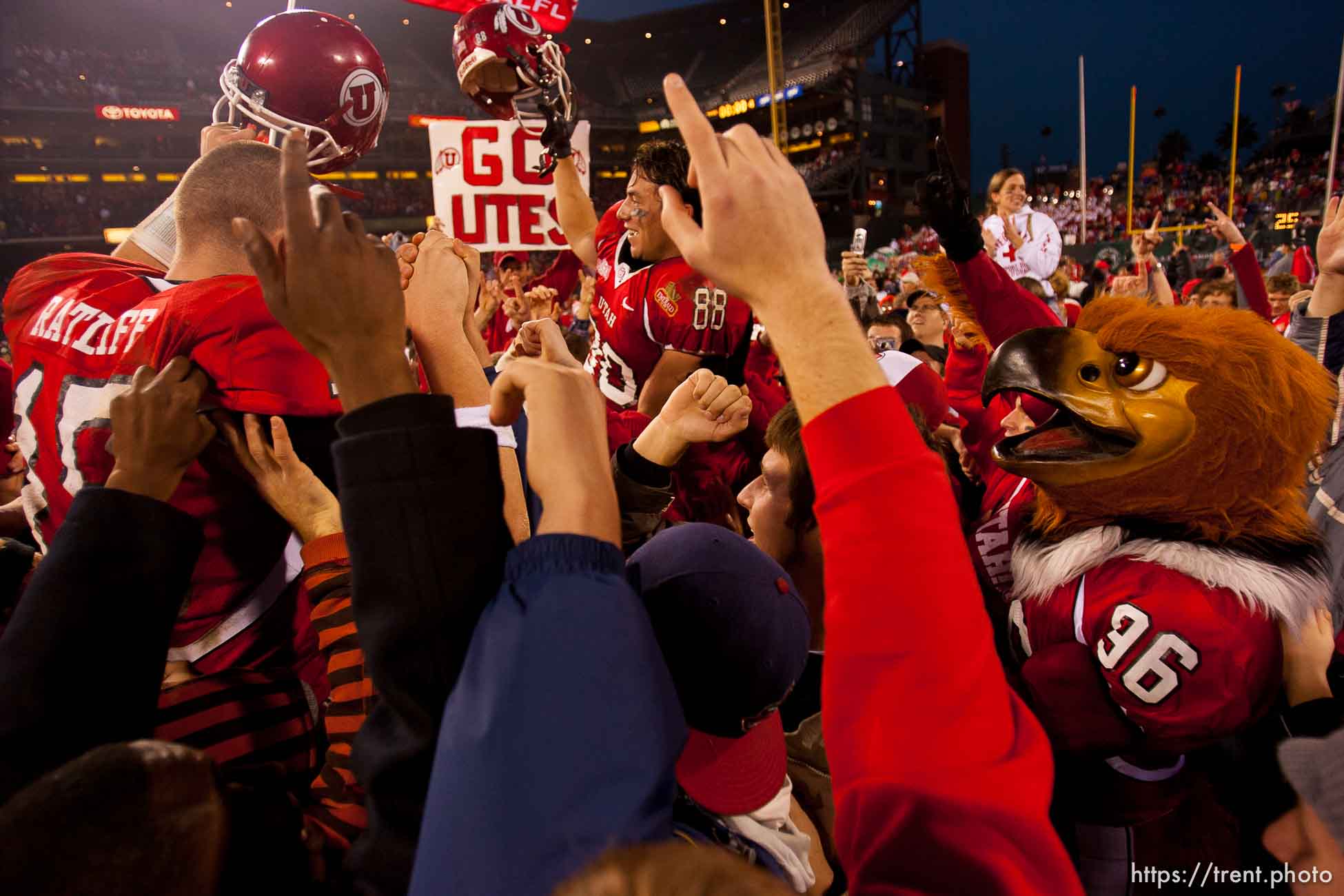 Utah quarterback Brett Ratliff and Travis LaTendresse (right) are lifted up by fans after the win. University of Utah vs. Georgia Tech, Emerald Bowl, San Francisco.