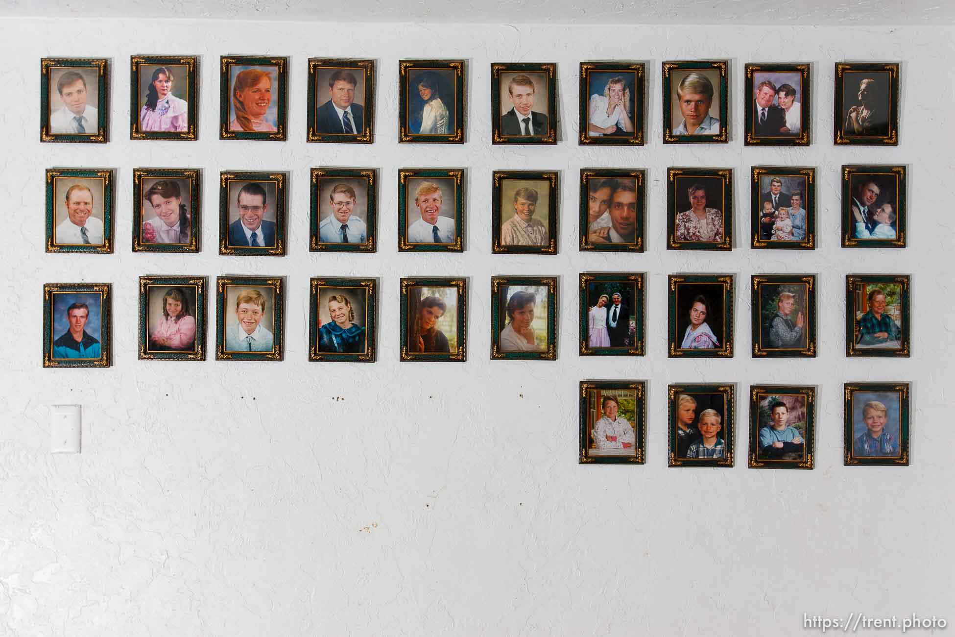 Marvin Wyler in his home with portraits of his 34 children