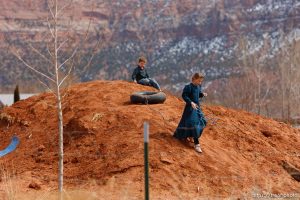 kids playing on mound of red dirt