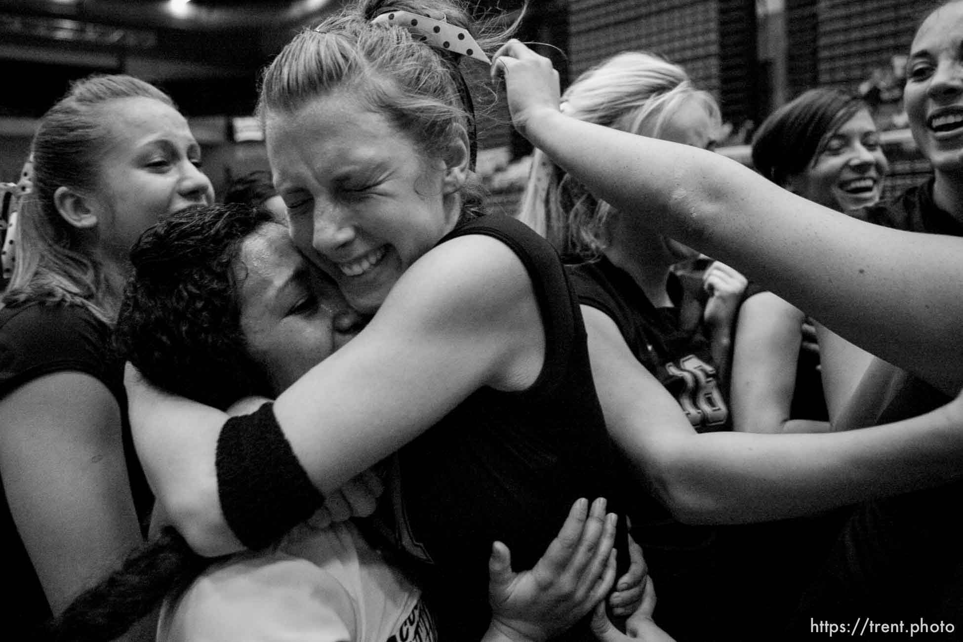 Orem - Cottonwood's Kylie Hudson (right) hugs teammate Trustine Mendoza as the team celebrates their state championship. Cottonwood defeats Murray for the 4A state championship, girls high school volleyball at UVSC.