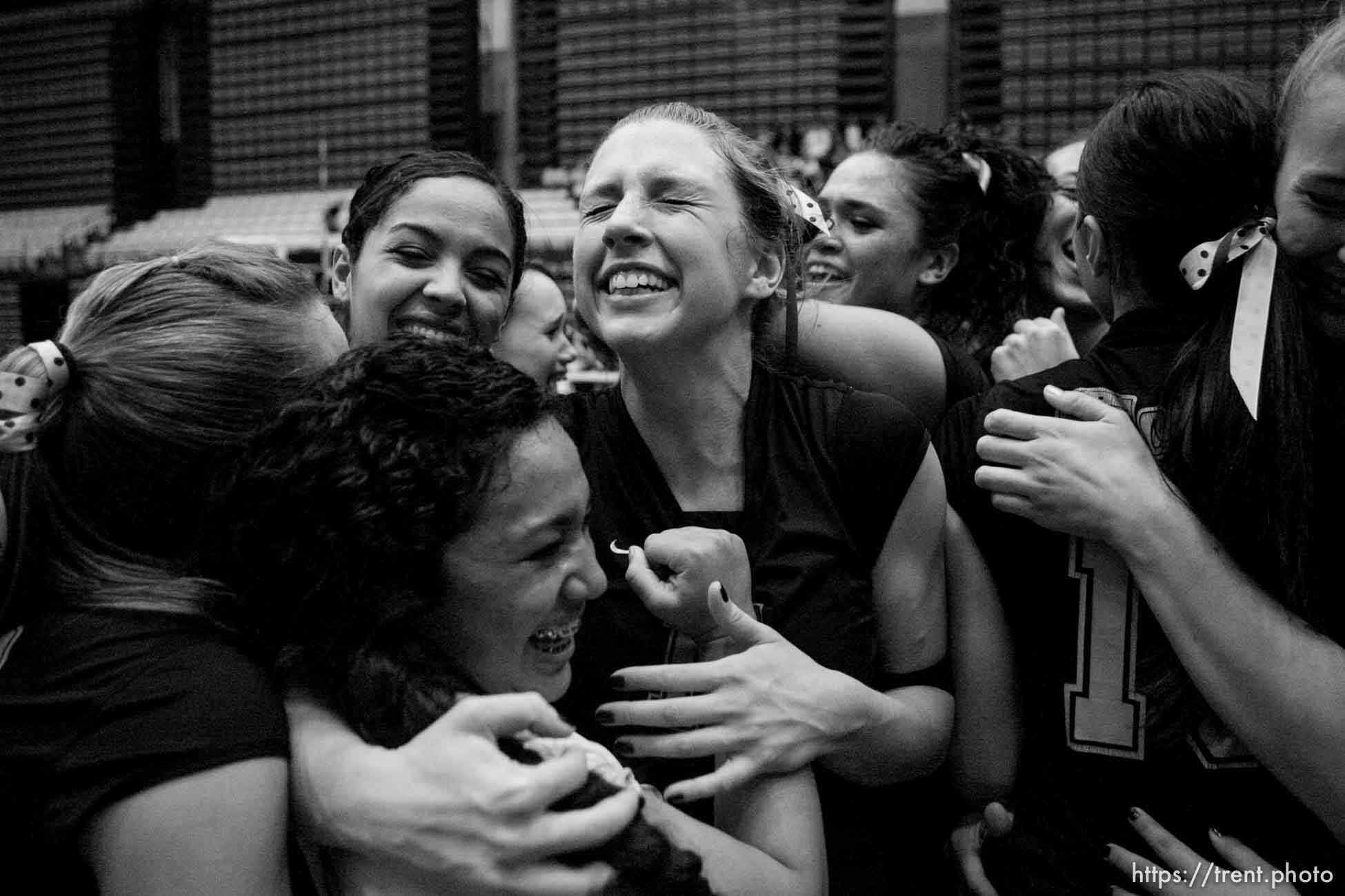 Orem - Cottonwood's Kylie Hudson (right) hugs teammate Trustine Mendoza as the team celebrates their state championship. Cottonwood defeats Murray for the 4A state championship, girls high school volleyball at UVSC.