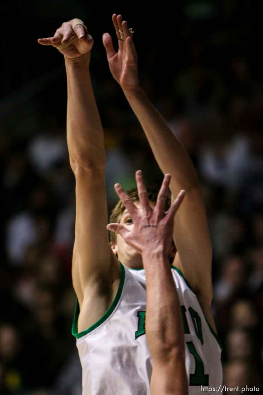 Ogden - Provo's Chris Collinsworth puts two of his ten first half points on the board, over Payson's Dustin Rowley. Provo vs. Payson High School boys basketball, 4A State Basketball Championship Game at the Dee Events Center Wednesday.