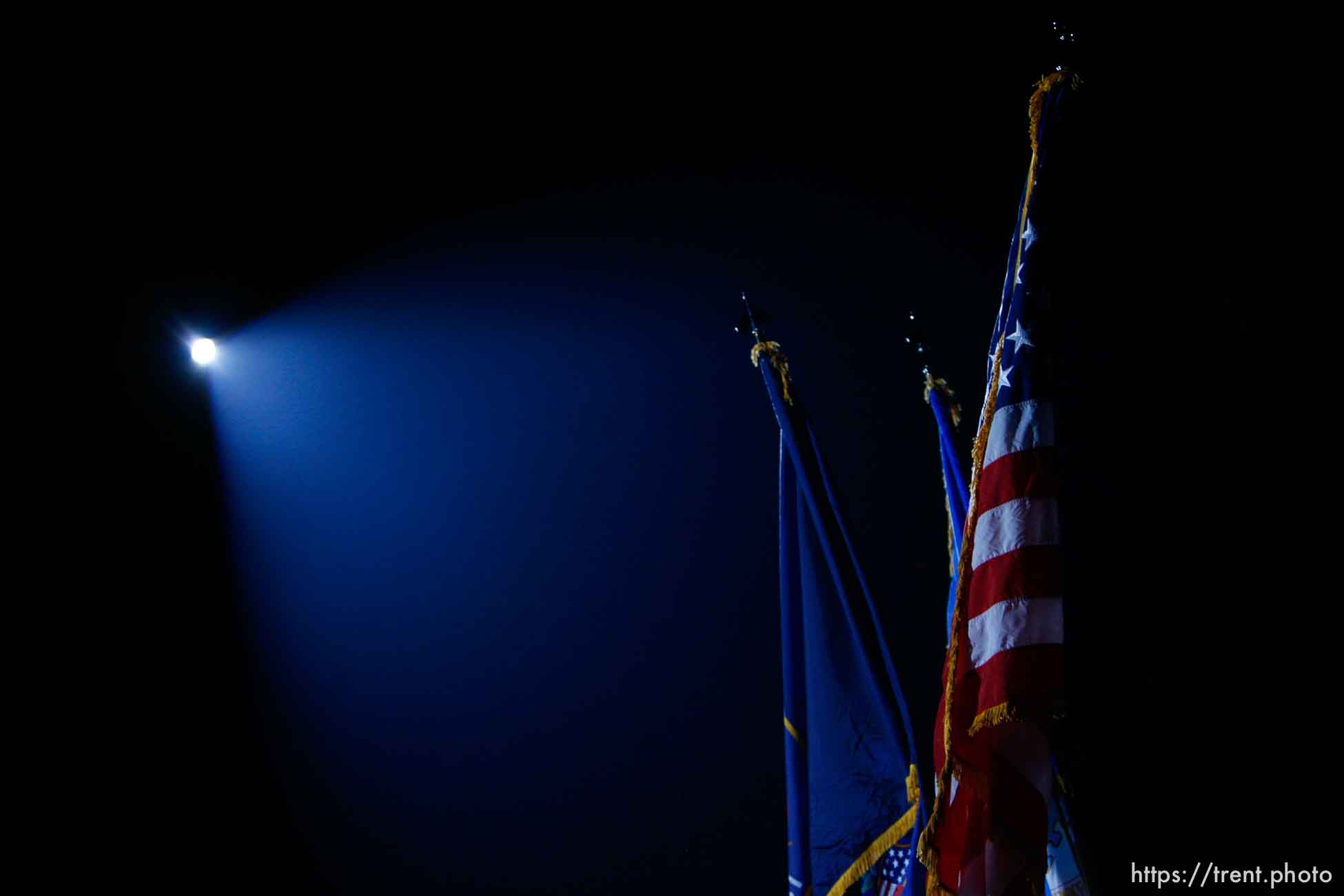 us flag under spotlight during national anthem