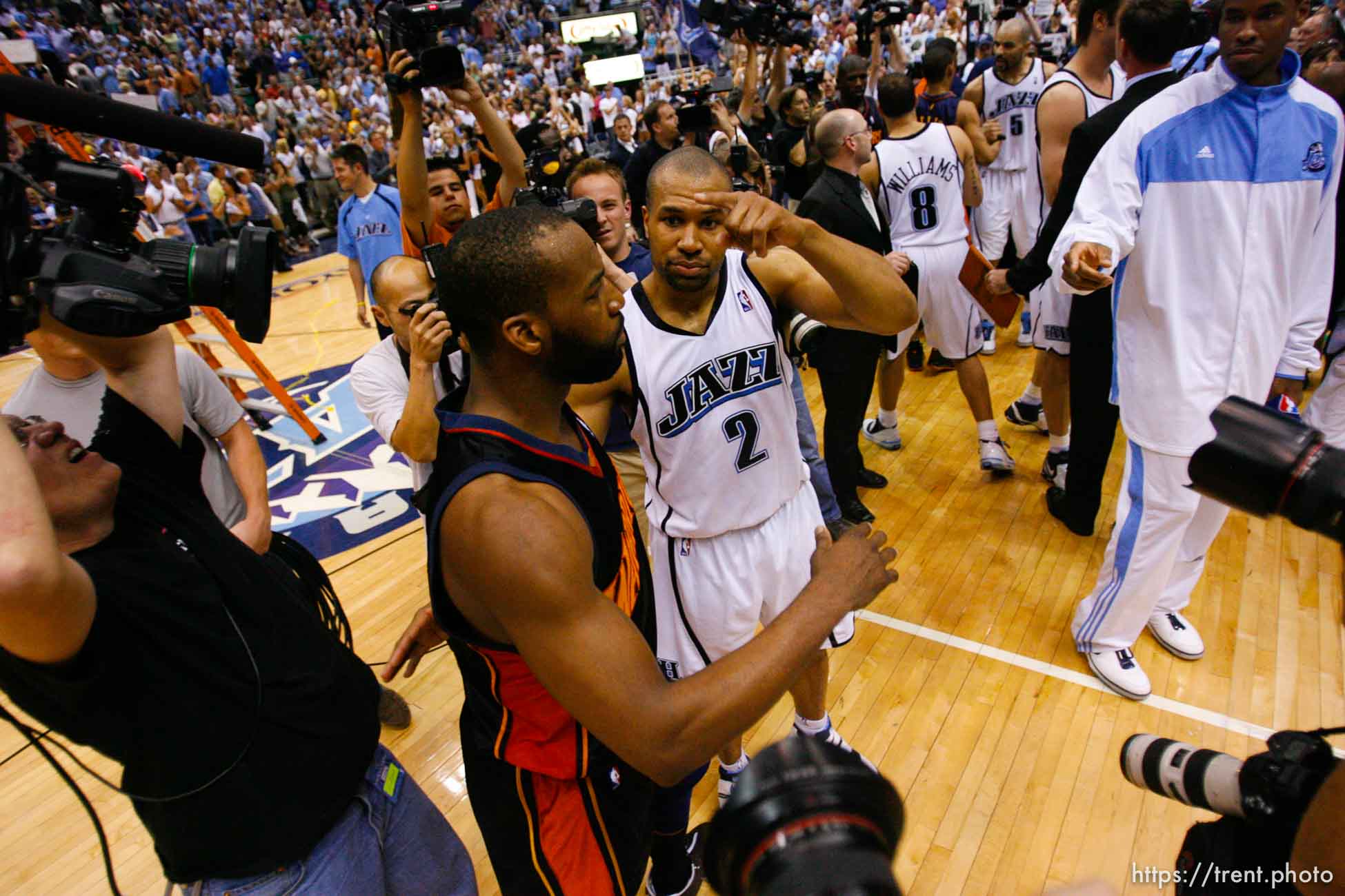 Salt Lake City - Golden State Warriors guard Baron Davis (5, left) and Utah Jazz guard Derek Fisher (2) embrace on the court following the Jazz victory. Utah Jazz vs. Golden State Warriors, NBA Playoff basketball, Game 5, at EnergySolutions Arena.