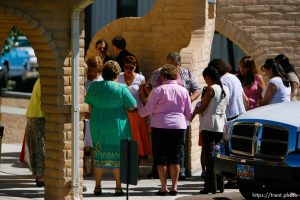 Huntington - Churchgoers form a prayer circle outside the San Rafael Mission before a mass led by Bishop John Wester for family members of the six trapped miners in the Crandall Canyon mine.