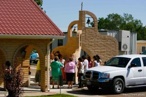 Huntington - Churchgoers form a prayer circle outside the San Rafael Mission before a mass led by Bishop John Wester for family members of the six trapped miners in the Crandall Canyon mine.