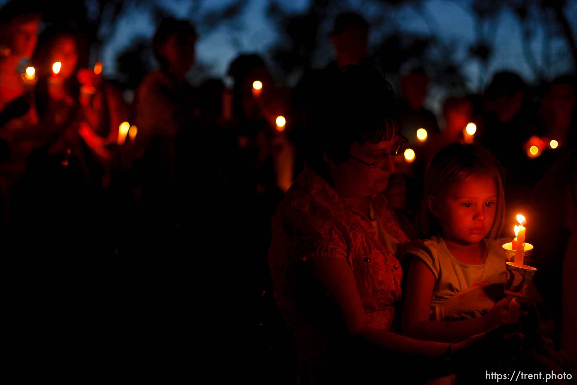 Huntington - Kelsee Thomas (right) with her grandmother Marcie Zwahlen hold a candle as members of the community turned out Friday night for a candlelight vigil for the six trapped miners in the Crandall Canyon Mine.