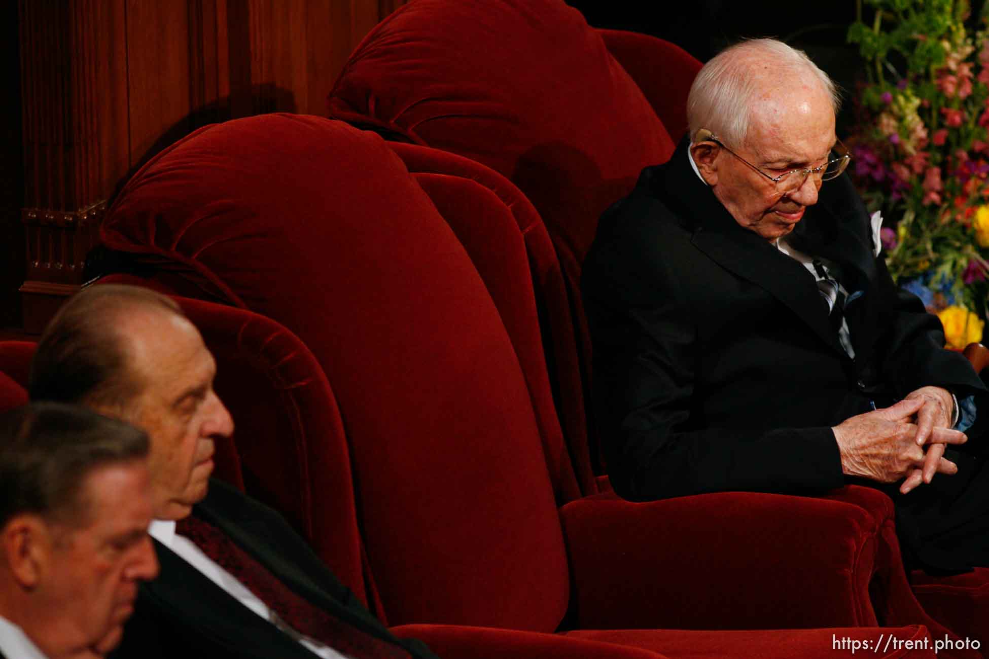 Salt Lake City - Seated next to an empty chair, LDS President Gordon B. Hinckley bows his head during the funeral for his counselor, President James E. Faust, a member of the First Presidency of the Church of Jesus Christ of Latter-day Saints. At left are Elder Jeffrey R. Holland (left) and President Thomas S. Monson.
; 8.14.2007