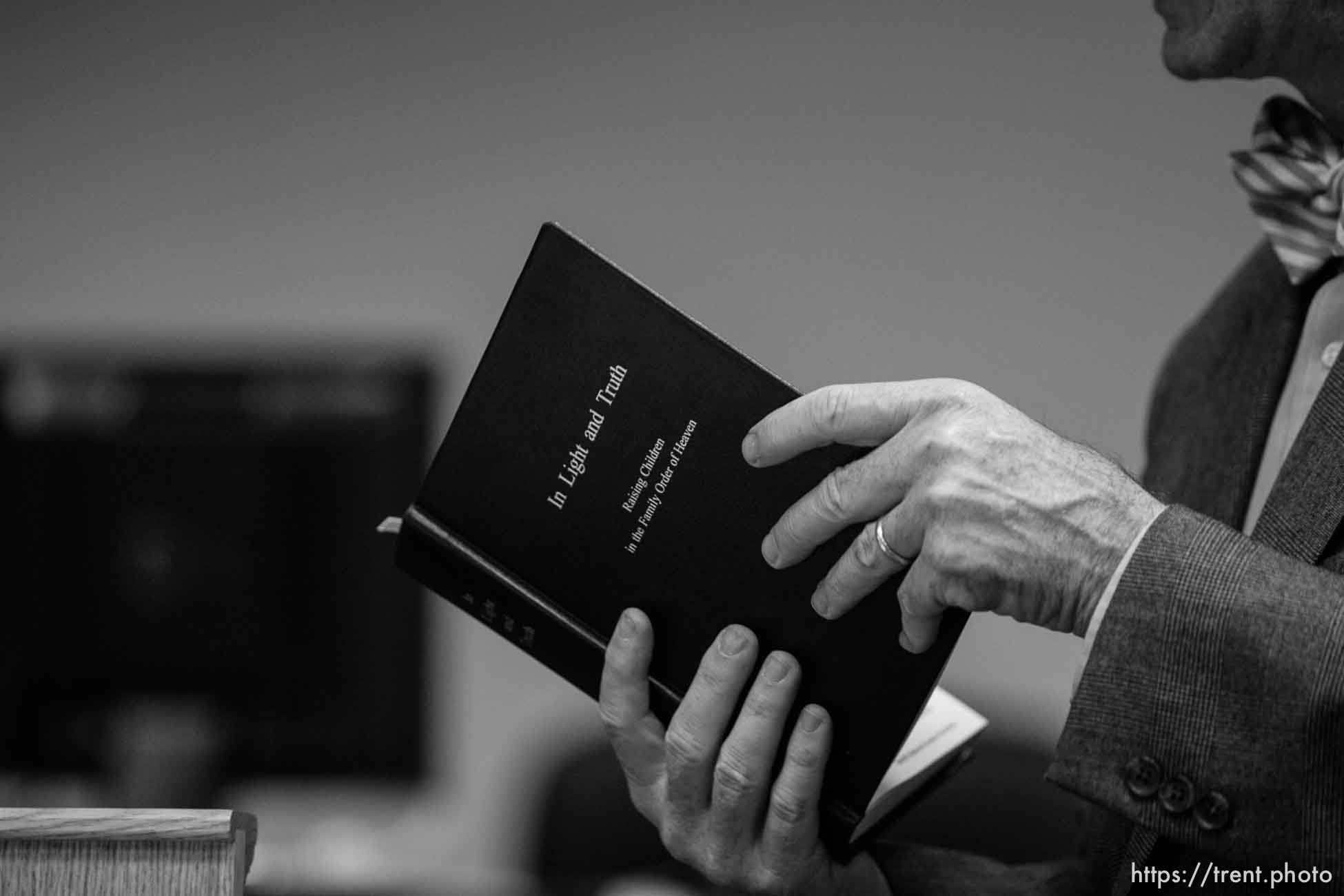 The Warren Jeffs' trial in St. George, Utah. Jeffs, head of the Fundamentalist Church of Jesus Christ of Latter Day Saints, is charged with two counts of rape as an accomplice for allegedly coercing the marriage and rape of a 14-year-old follower to her 19-year-old cousin in 2001.. defense attorney Walter Bugden with a copy of in light and truth, an FLDS book