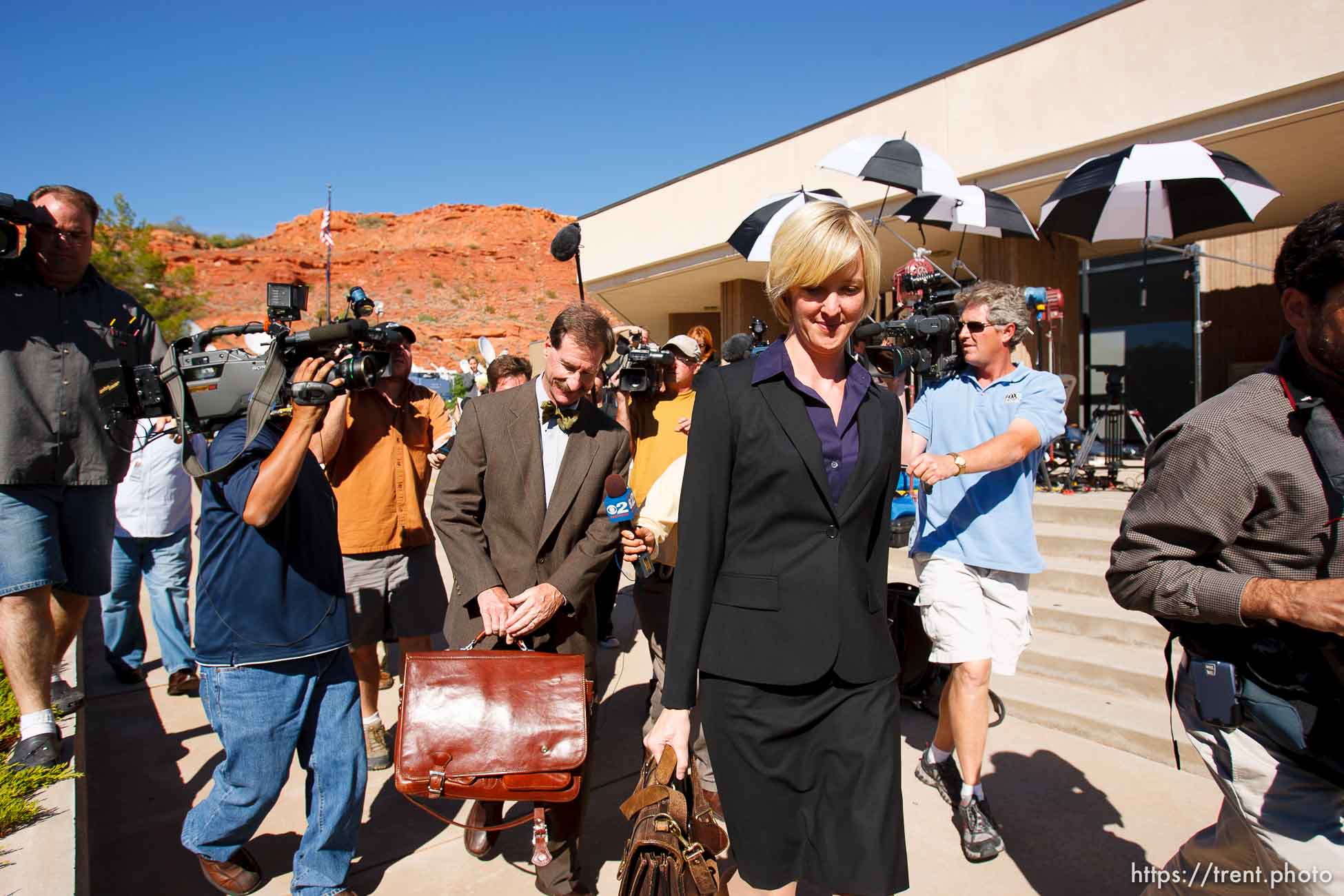 defense attorney Tara Isaacson, Walter Bugden and media. St. George - Warren Jeffs trial. The polygamous sect leader was charged with two counts of rape as an accomplice stemming from a marriage he officiated involving a 14-year-old girl and her 19-year-old cousin.