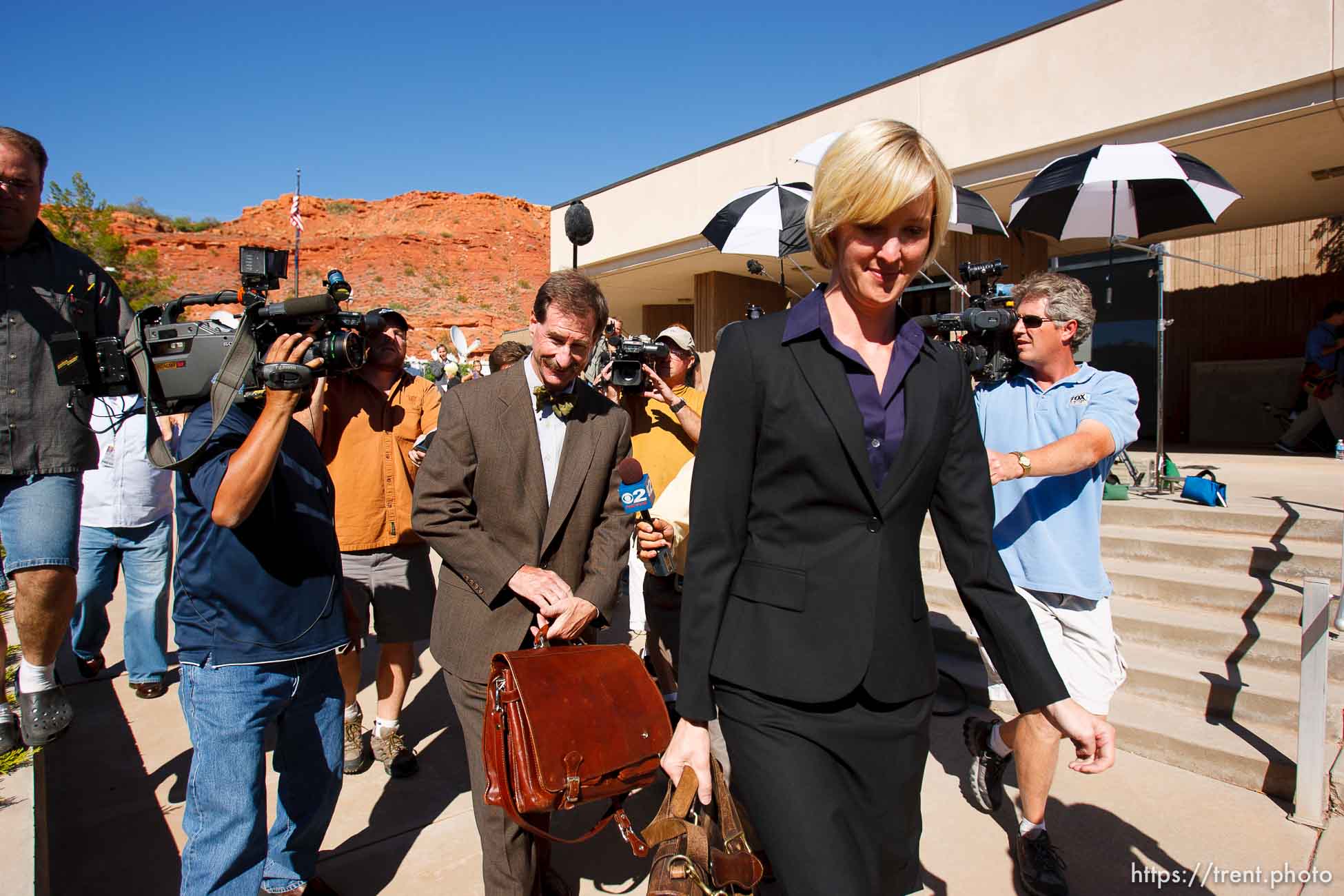 defense attorney Tara Isaacson, Walter Bugden and media. St. George - Warren Jeffs trial. The polygamous sect leader was charged with two counts of rape as an accomplice stemming from a marriage he officiated involving a 14-year-old girl and her 19-year-old cousin.