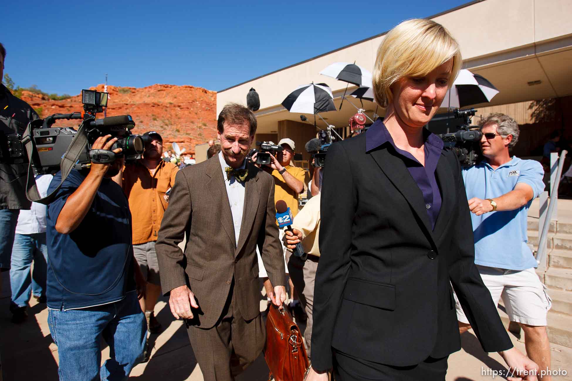 defense attorney Tara Isaacson, Walter Bugden and media. St. George - Warren Jeffs trial. The polygamous sect leader was charged with two counts of rape as an accomplice stemming from a marriage he officiated involving a 14-year-old girl and her 19-year-old cousin.