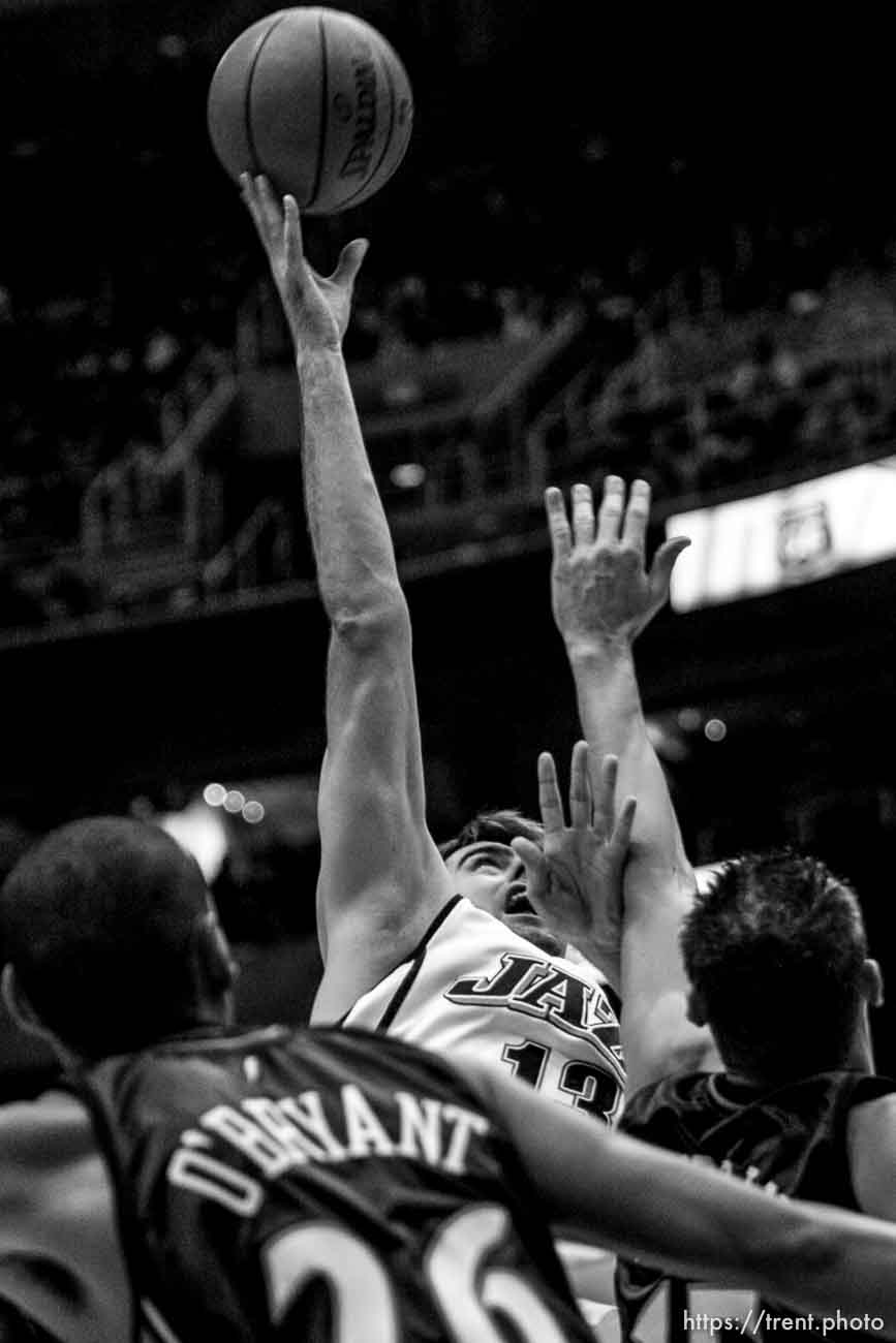 Salt Lake City - Utah Jazz center Mehmet Okur (13) scores two with Golden State Warriors center Patrick O'Bryant (26)  and Golden State Warriors forward Andris Biedrins (15) defending. Utah Jazz vs. Golden State Warriors, NBA basketball Saturday night at EnergySolutions Arena.