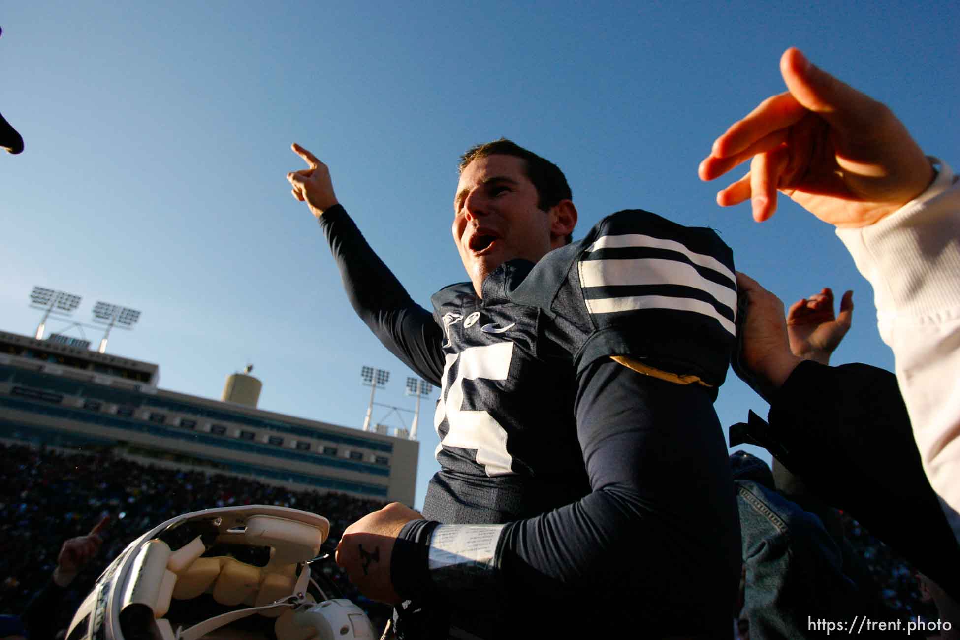 Provo - BYU fans hold Brigham Young quarterback Max Hall (15) on their shoulders, celebrating victory as BYU defeats the University of Utah 17-10 in college football action Saturday at BYU's Lavell Edward Stadium.