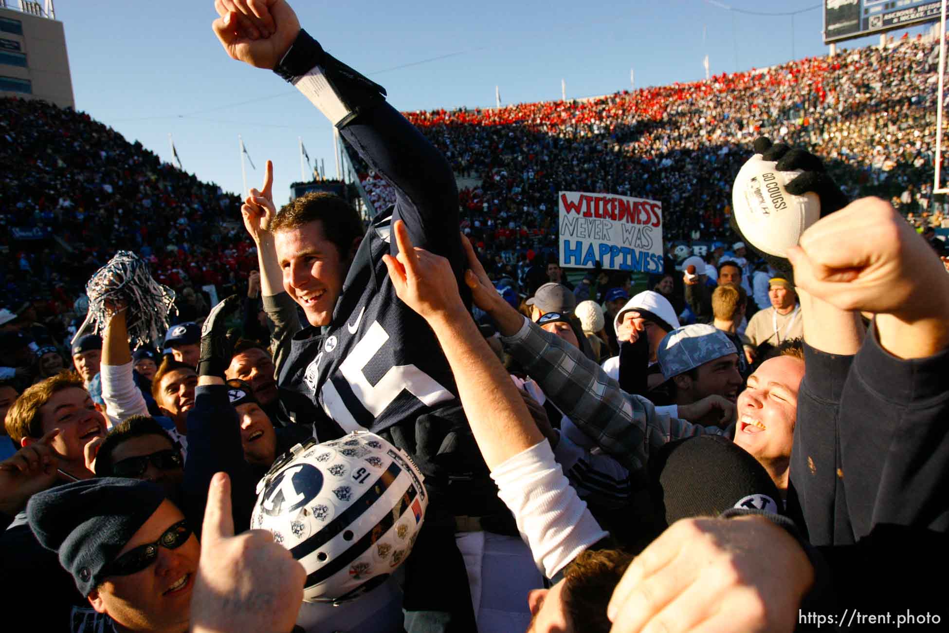 Provo - BYU fans hold Brigham Young quarterback Max Hall (15) on their shoulders, celebrating victory as BYU defeats the University of Utah 17-10 in college football action Saturday at BYU's Lavell Edward Stadium.