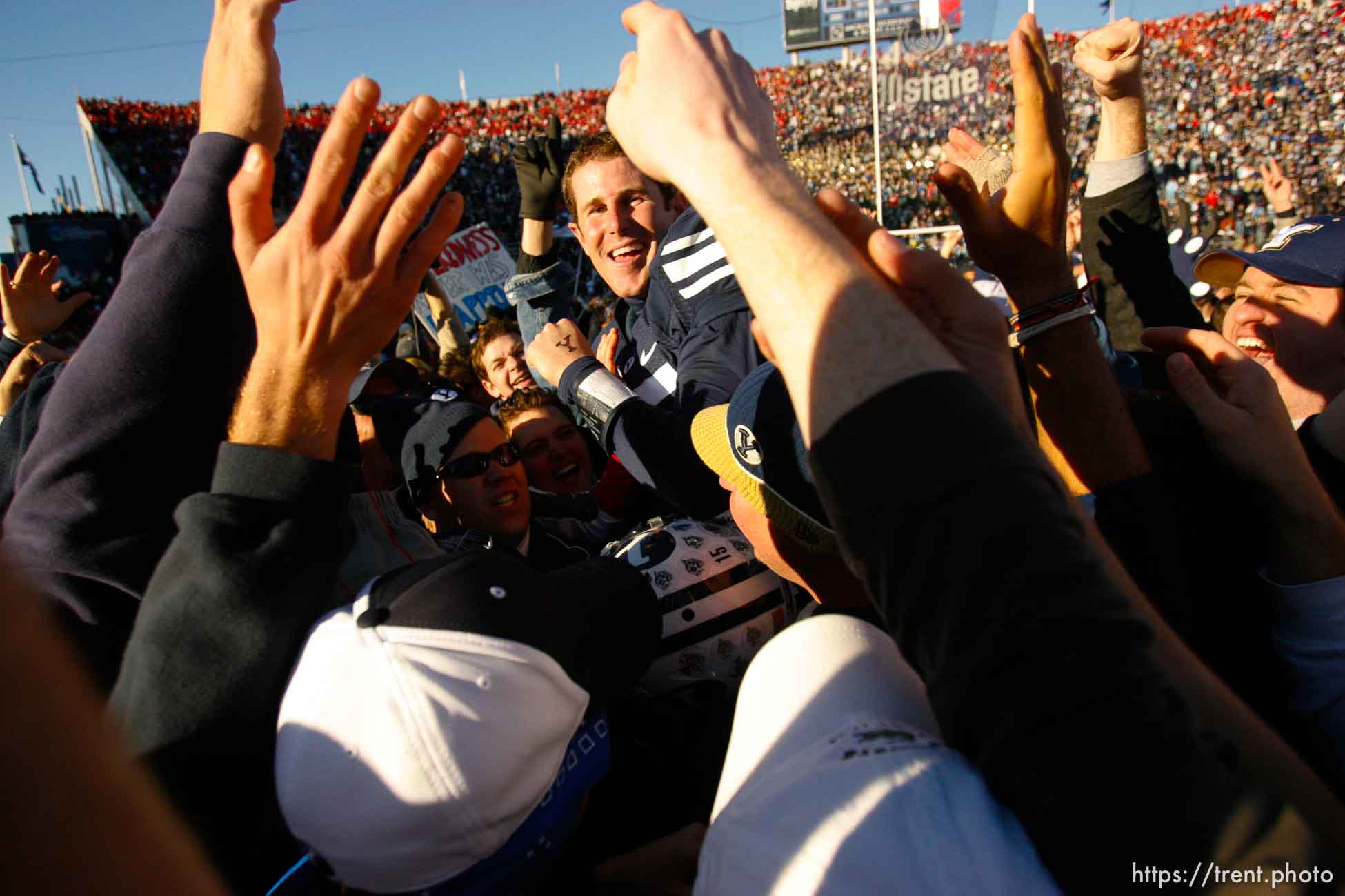 Provo - BYU fans hold Brigham Young quarterback Max Hall (15) on their shoulders, celebrating victory as BYU defeats the University of Utah 17-10 in college football action Saturday at BYU's Lavell Edward Stadium.