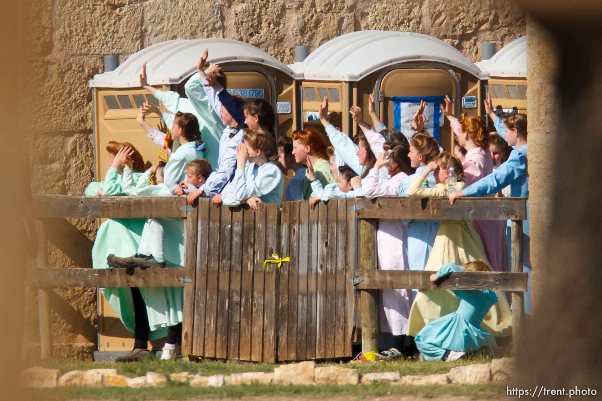 San Angelo - FLDS women stand behind a fence at Fort Concho, waving to other FLDS women in another building and to news photographers. Texas Child Protective Services said they have taken 401 children from the YFZ Ranch into protective custody as of Monday, April 7, 2008 and brought them to Fort Concho.