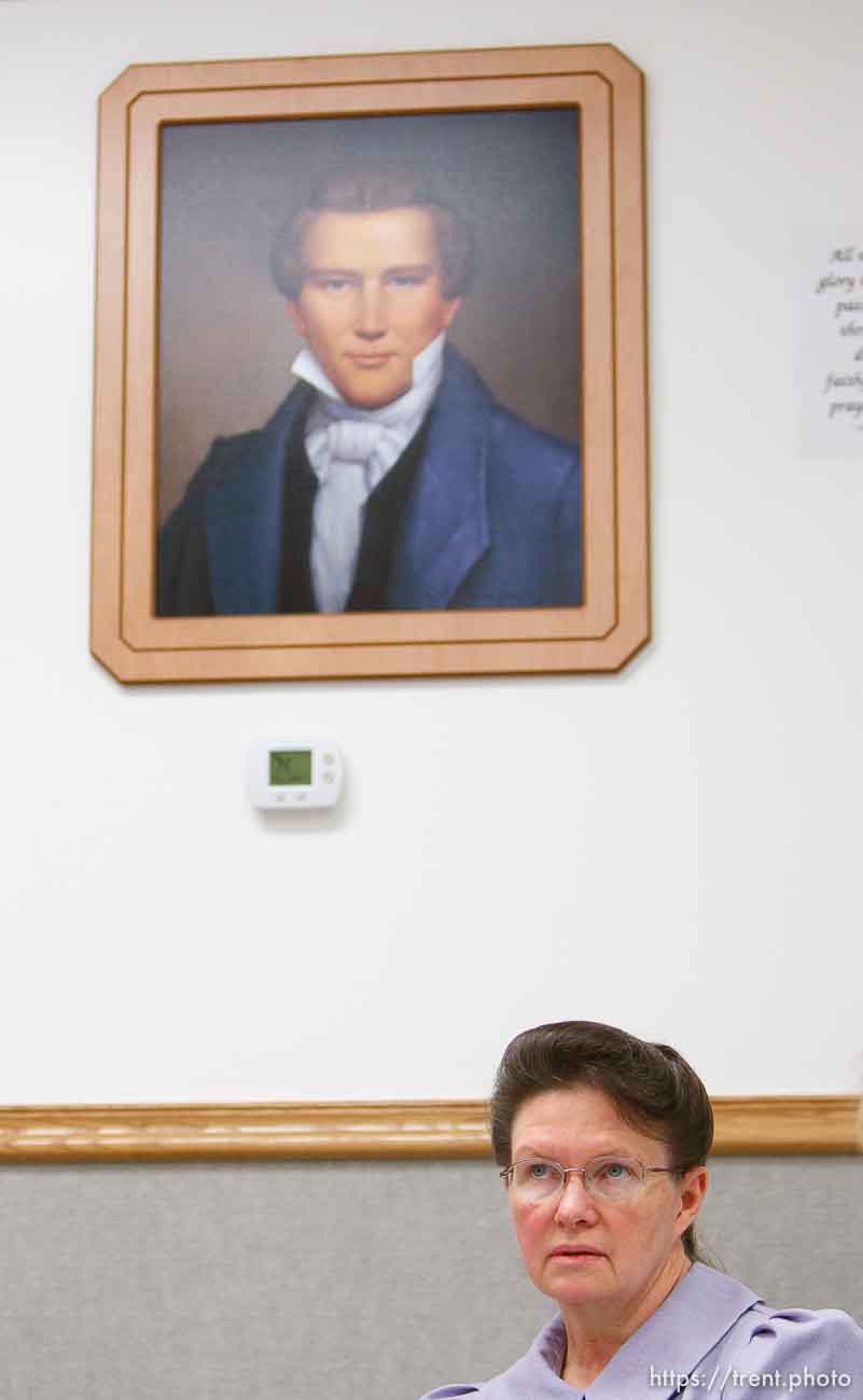 Marianne, an FLDS woman on the YFZ Ranch Wednesday, April 16, 2008, tells the story of being taken with her four daughters in the raid. Above her is a portrait of Joseph Smith, which both the polygamous FLDS and mainstream LDS church revere as a founding prophet.