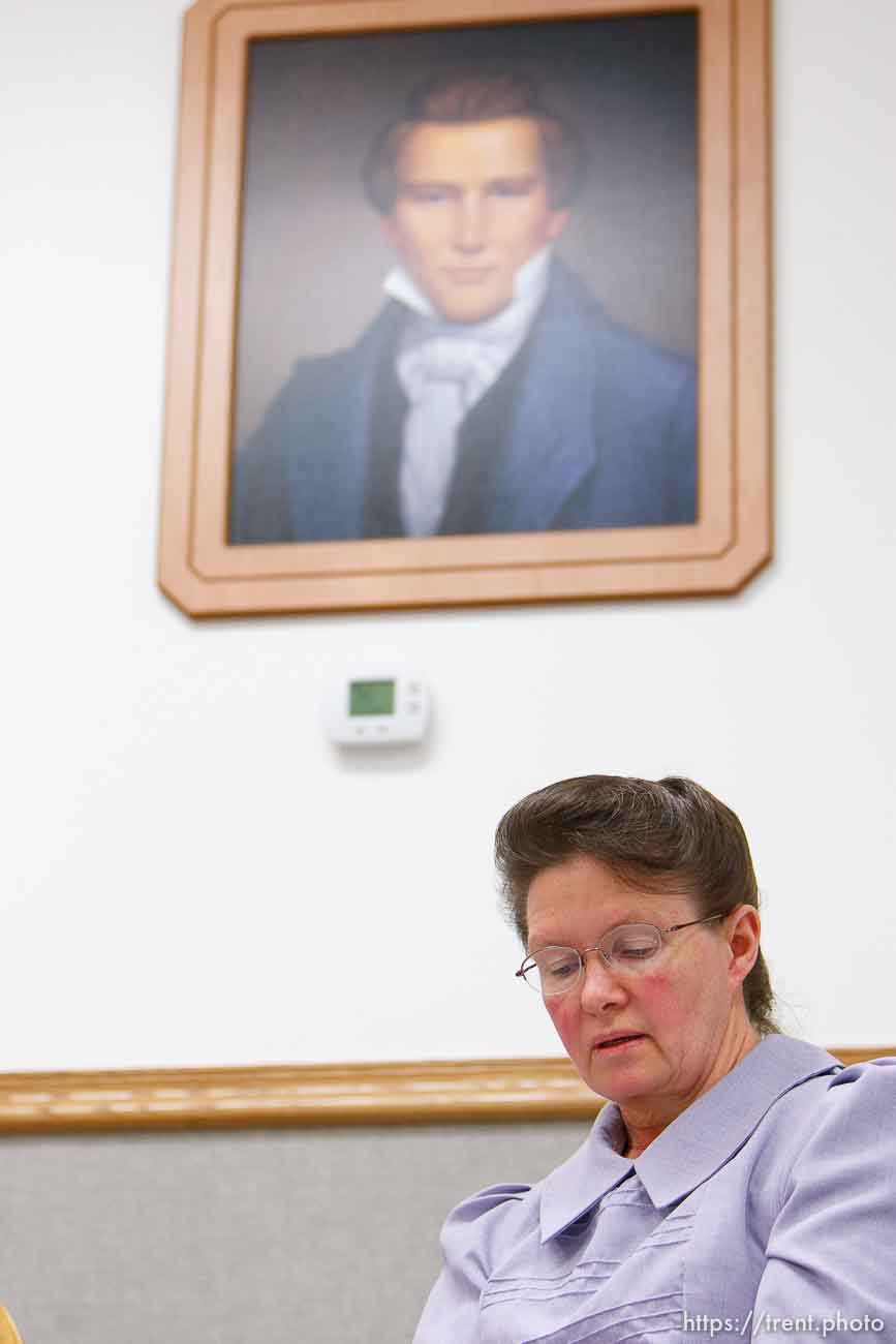 Marianne, an FLDS woman on the YFZ Ranch Wednesday, April 16, 2008, tells the story of being taken with her four daughters in the raid. Above her is a portrait of Joseph Smith, which both the polygamous FLDS and mainstream LDS church revere as a founding prophet.