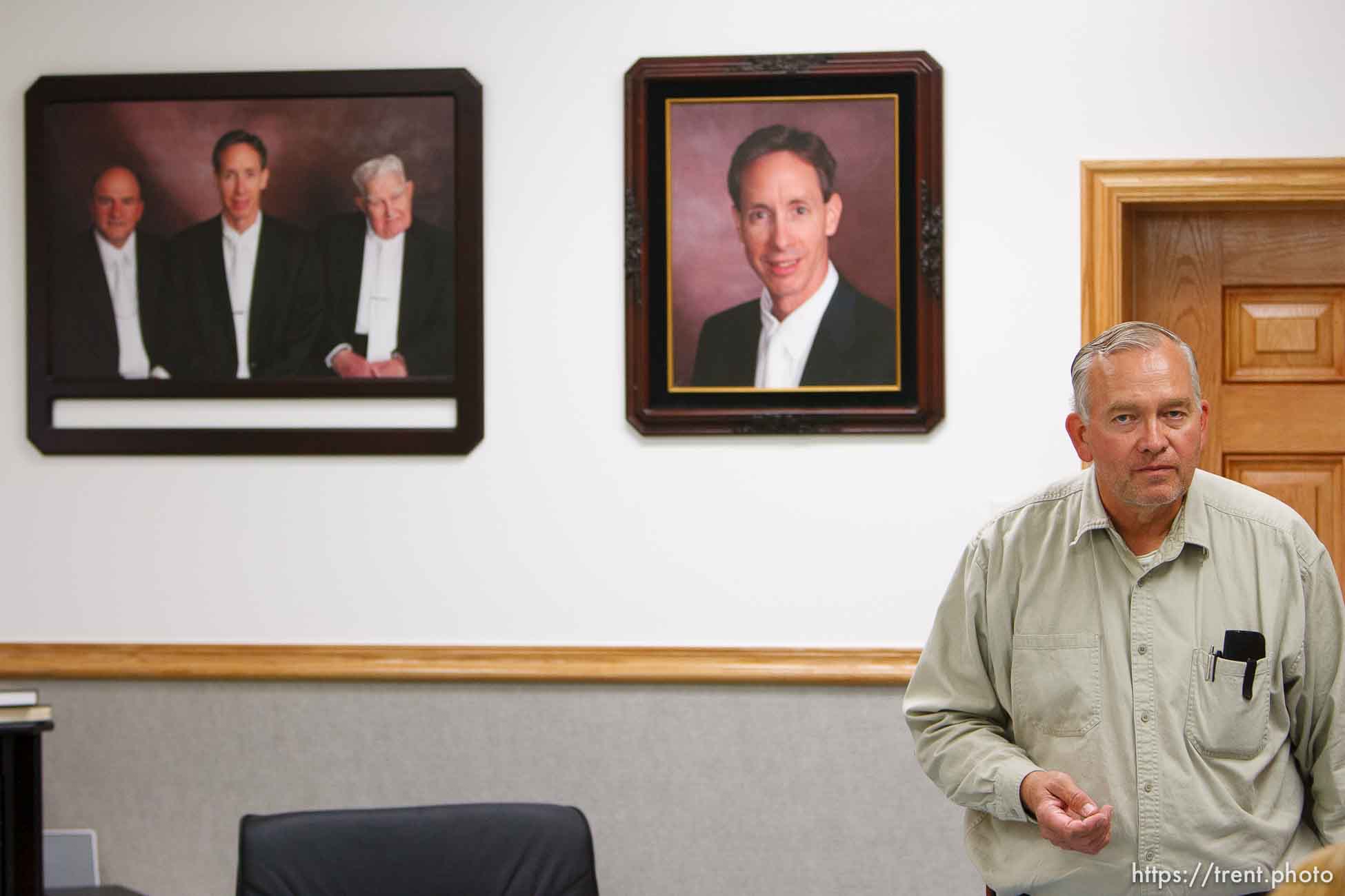 Lamar Johnson in his home on the YFZ Ranch Wednesday, April 16, 2008, talks about his children, taken in the raid. On the wall are portraits of FLDS leaders Warren Jeffs, Wendell Nielsen and Fred Jessop..  Wednesday April 16, 2008.