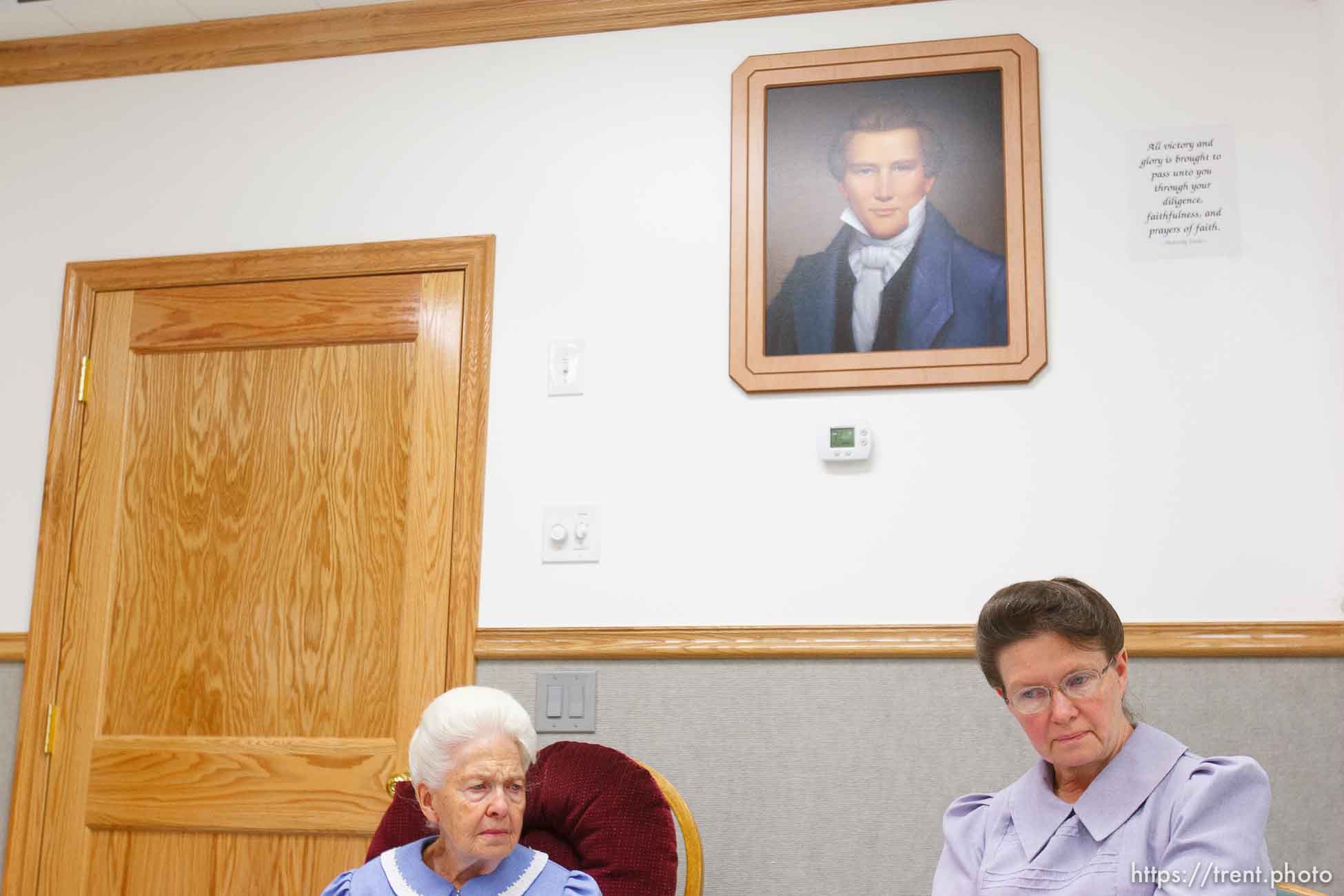 Marianne, an FLDS woman on the YFZ Ranch Wednesday, April 16, 2008, tells the story of being taken with her four daughters in the raid. Above her is a portrait of Joseph Smith, which both the polygamous FLDS and mainstream LDS church revere as a founding prophet.