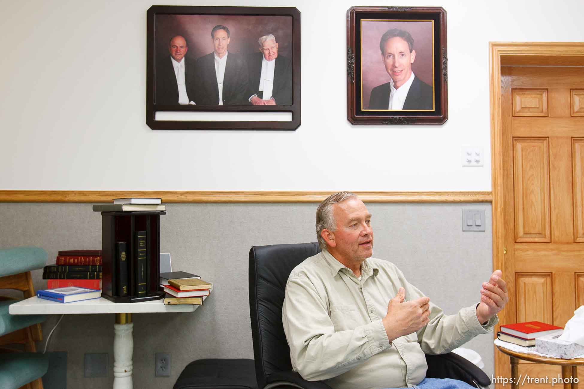 Lamar Johnson in his home on the YFZ Ranch Wednesday, April 16, 2008, talks about his children, taken in the raid. On the wall are portraits of FLDS leaders Warren Jeffs, Wendell Nielsen and Fred Jessop.