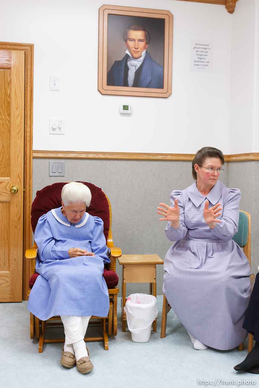 Marianne, an FLDS woman on the YFZ Ranch Wednesday, April 16, 2008, tells the story of being taken with her four daughters in the raid. Above her is a portrait of Joseph Smith, which both the polygamous FLDS and mainstream LDS church revere as a founding prophet.