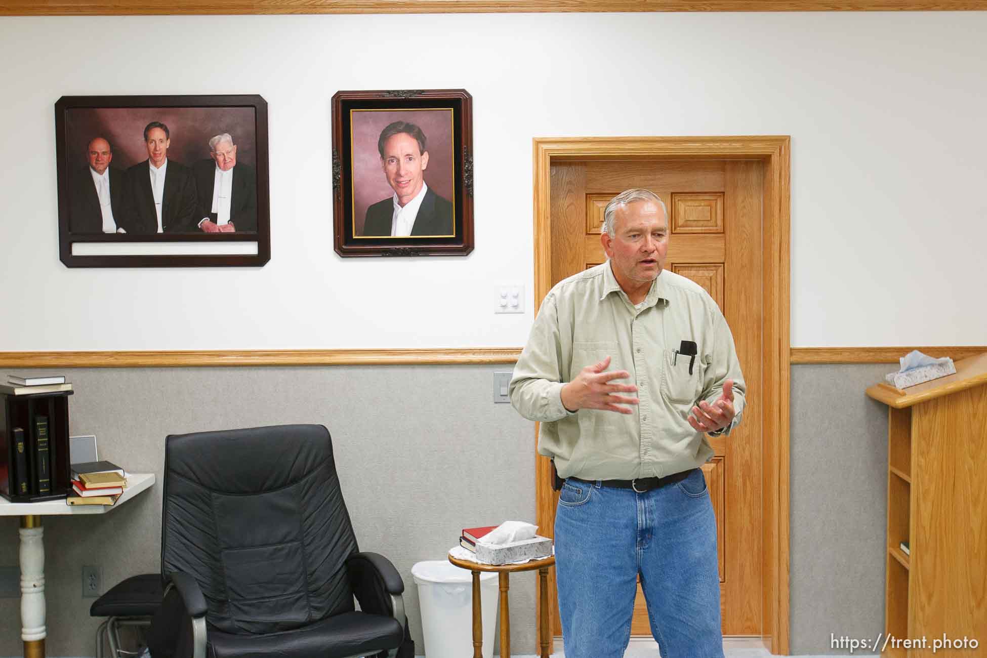 Lamar Johnson in his home on the YFZ Ranch Wednesday, April 16, 2008, talks about his children, taken in the raid. On the wall are portraits of FLDS leaders Warren Jeffs, Wendell Nielsen and Fred Jessop.