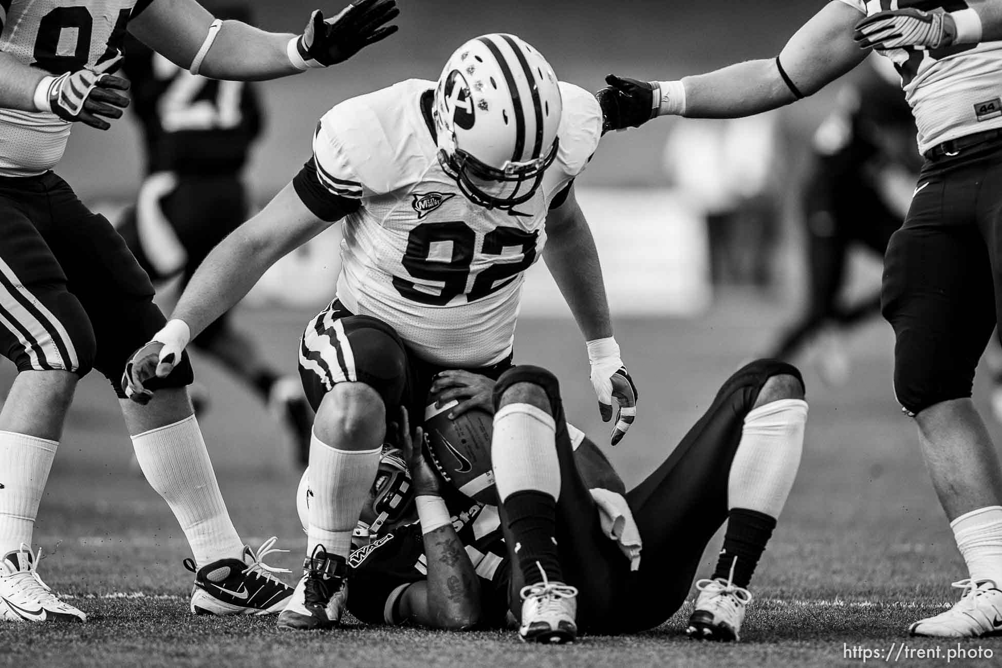 Logan - BYU vs. Utah State University (USU) college football Friday, October 3, 2008. BYU defensive lineman Brett Denney (92) sits on USU QB Diondre Borel after sacking him.