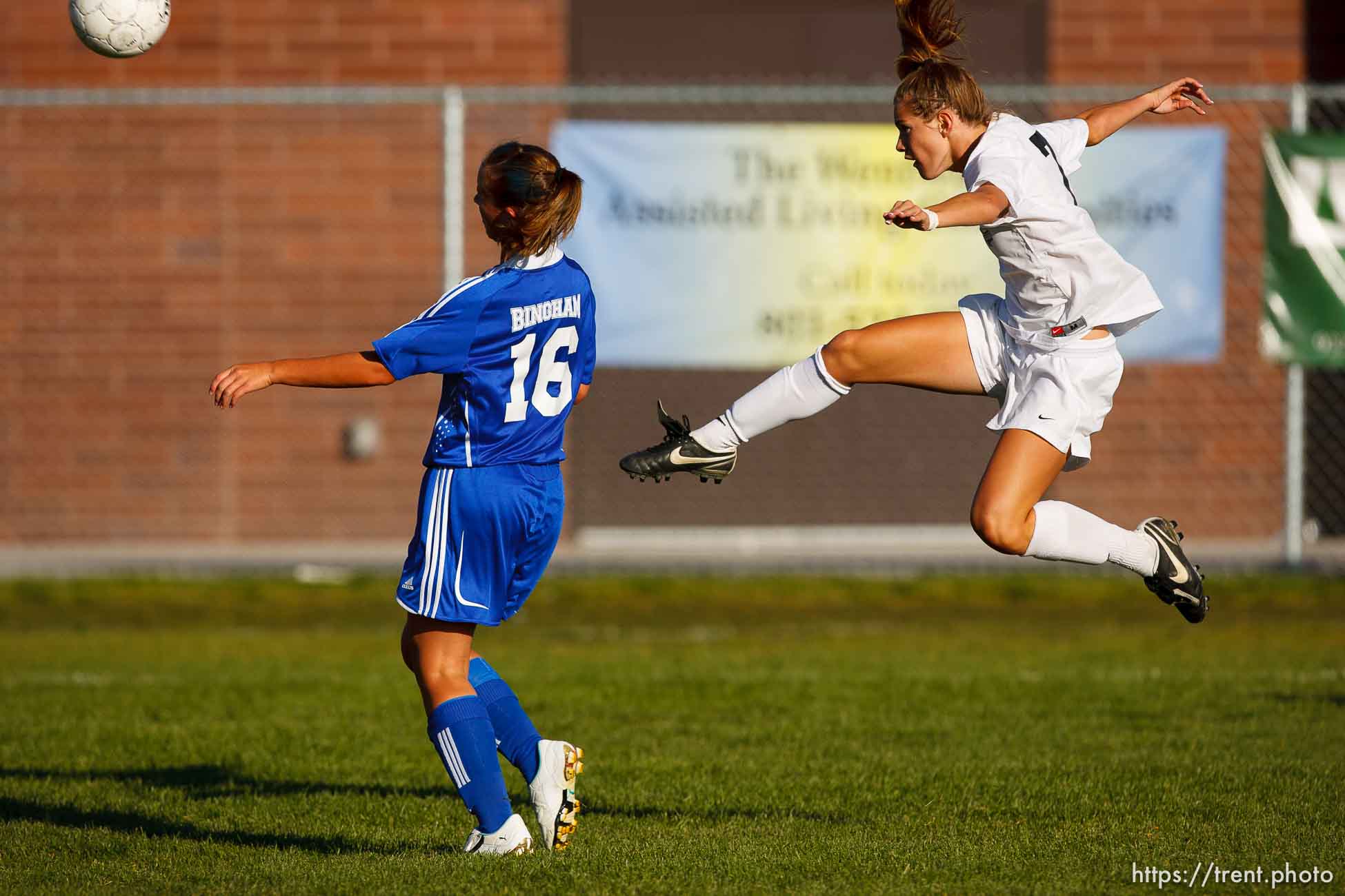 Sandy - Alta's Kealia Ohai scores with a mid-air kick. Bingham's Paige Densley defending. Alta vs. Bingham girls high school soccer, 5A playoffs, Thursday, October 16, 2008. Alta wins at home 5-0.