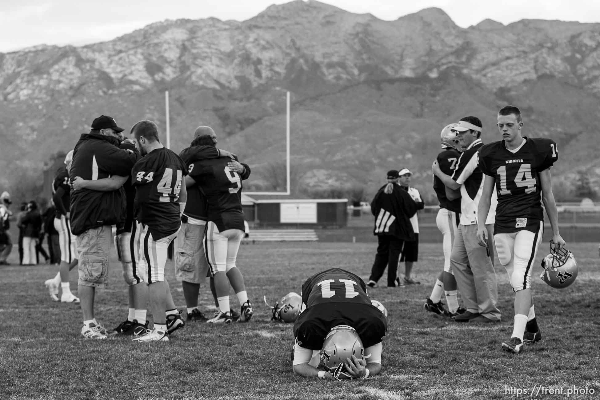 Highland - Lone Peak players console each other after the season-ending loss. At center is Chase Dunford (11) and at right is Jared Hultquist (14). Lone Peak loses to Skyline in high school football playoff action Friday, October 31, 2008, at Lone Peak.